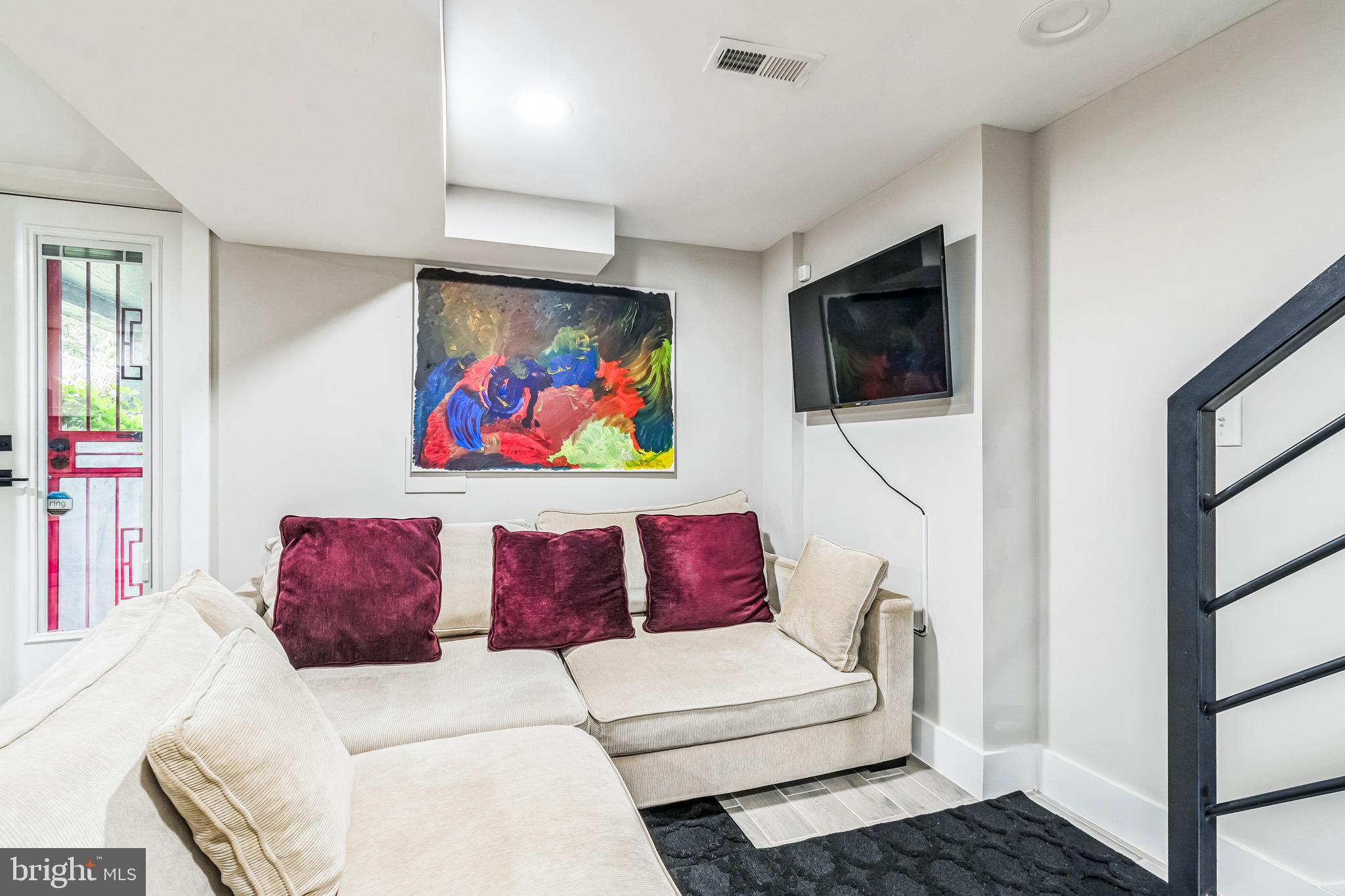 805 B Jefferson Street Northwest Washington, DC 20011 - Photo 6 of 16 a living room with furniture and a flat screen tv