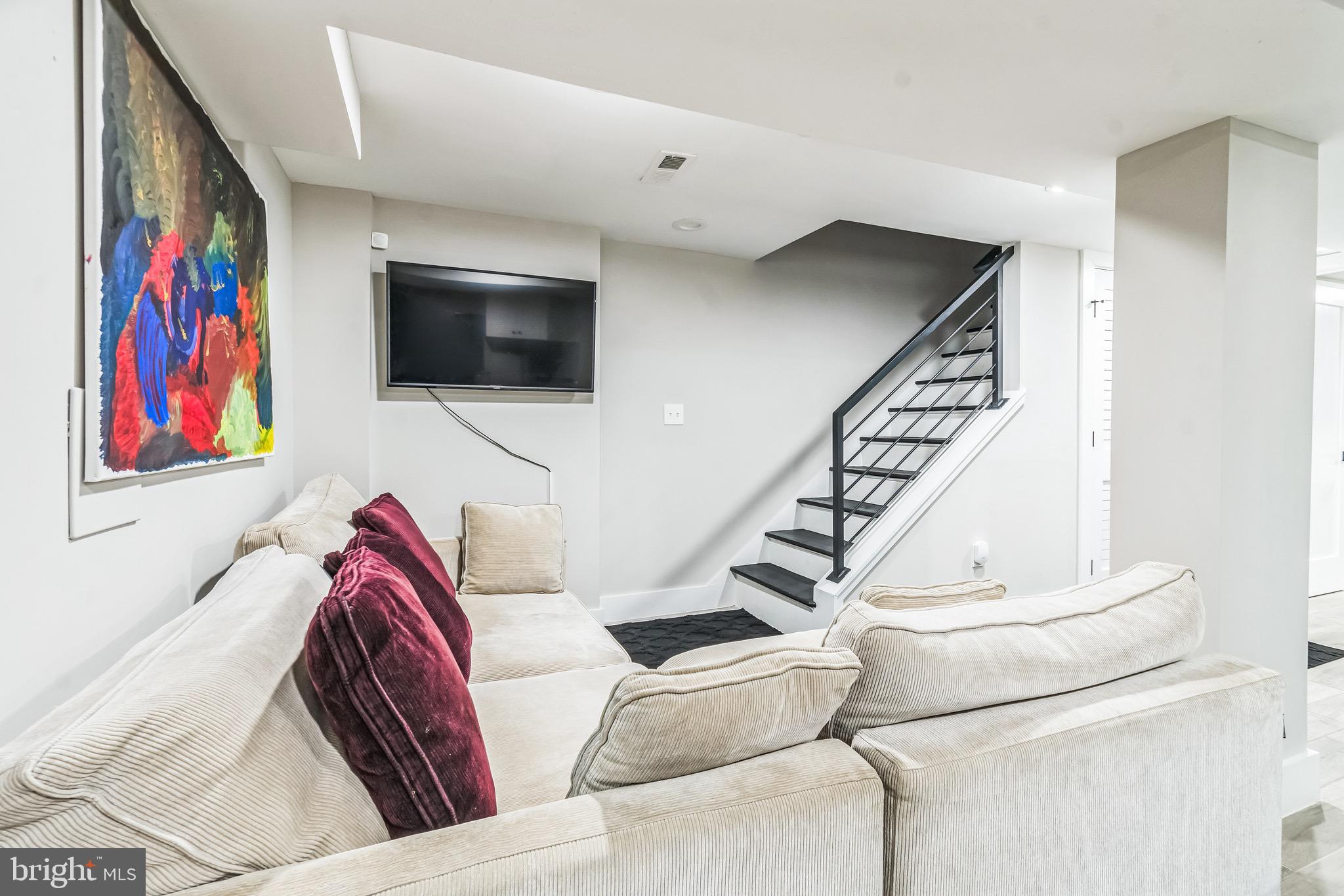 805 B Jefferson Street Northwest Washington, DC 20011 - Photo 7 of 16 a living room with furniture and a flat screen tv
