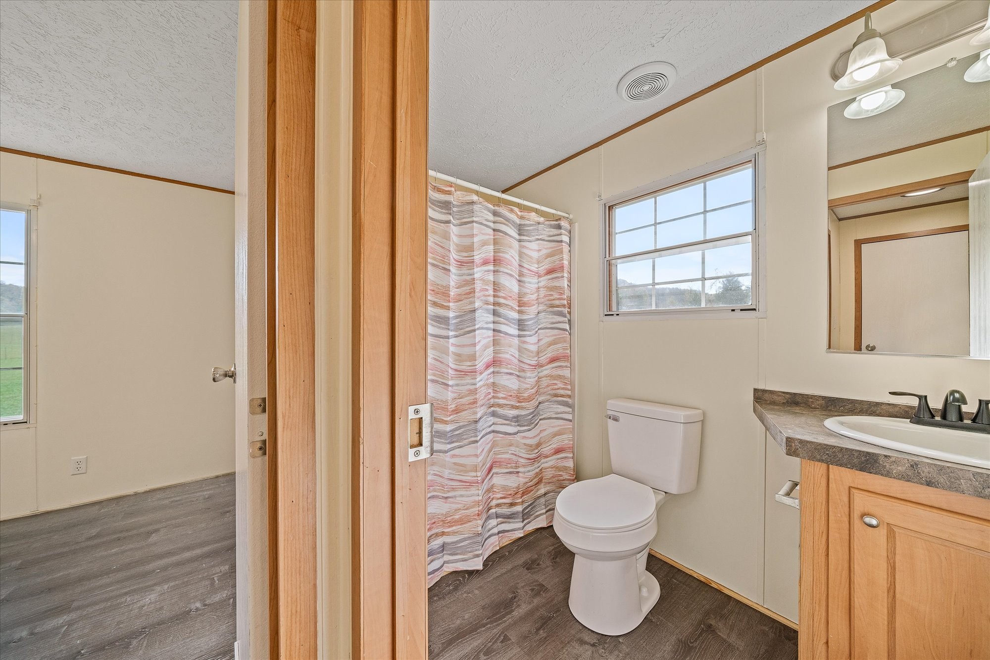 1476 Conrad Templeton Road Quebeck, TN 38579 - Photo 20 of 31 a bathroom with a toilet a sink and a window