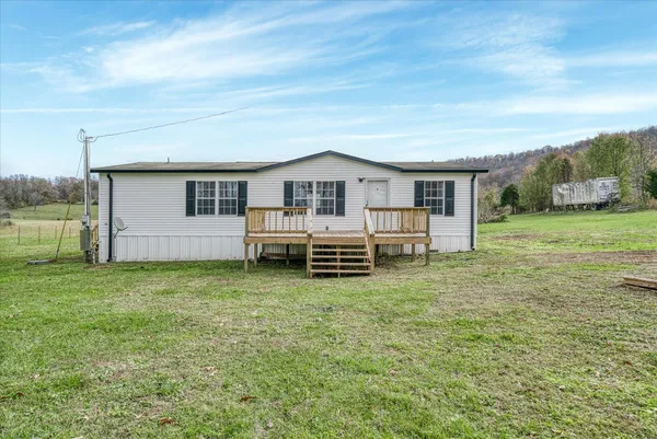 a view of a house with a backyard