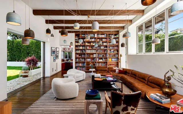a view of a patio with couches table and chairs and potted plants