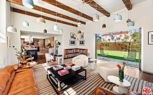 a living room with furniture and a floor to ceiling window