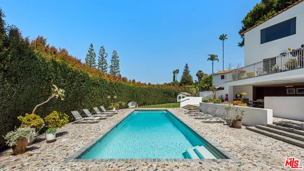 a view of a swimming pool with lounge chair