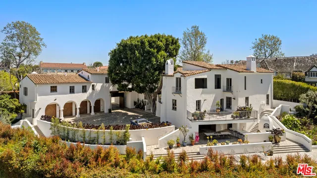a front view of a house with a fountain
