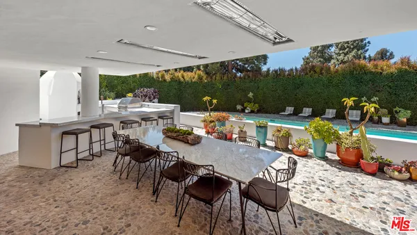 a view of a patio with a table and chairs