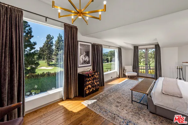 a living room with furniture large window with wooden floor
