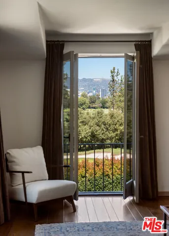 a living room with a large window and a table