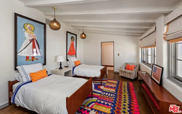 a bedroom with furniture and a large window