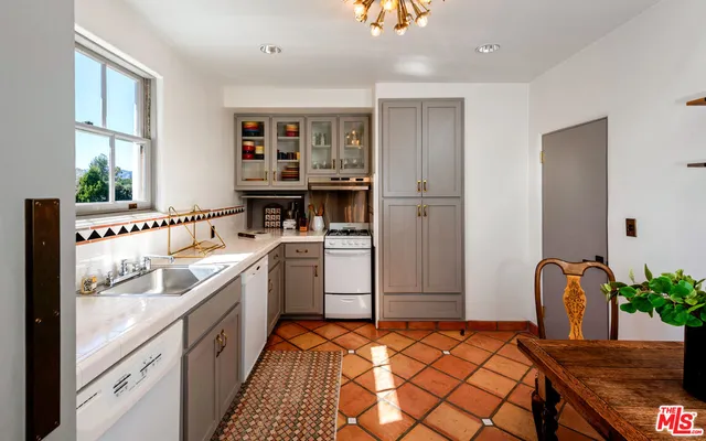 a kitchen with a refrigerator and a sink