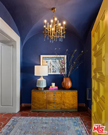 a living room with a couch and chandelier