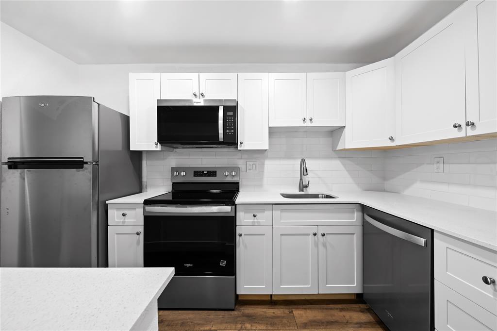 a kitchen with cabinets stainless steel appliances and sink