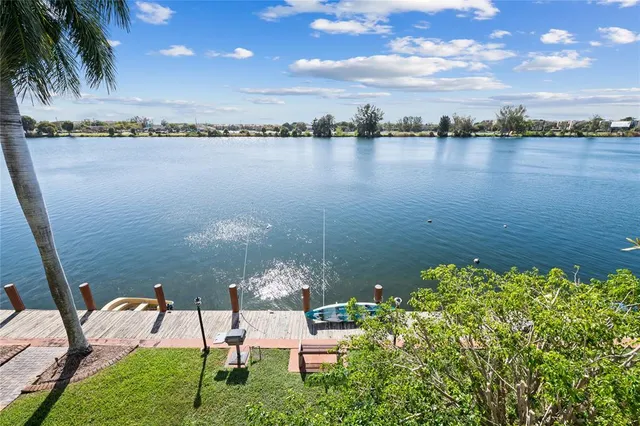 a view of a lake with table and chairs