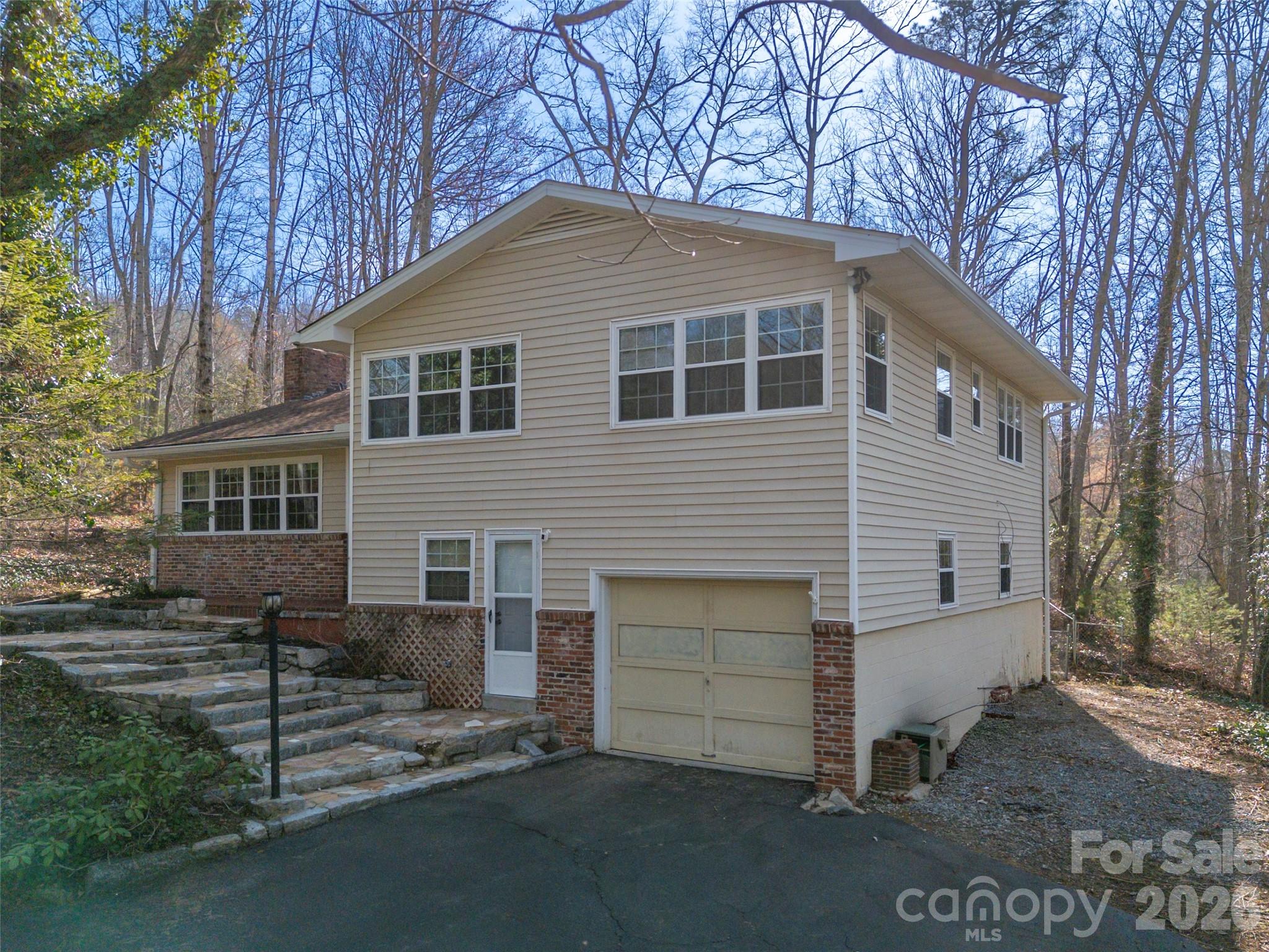 3 Country Road Hendersonville, NC 28791 - Photo 1 of 48 a front view of a house with a garage