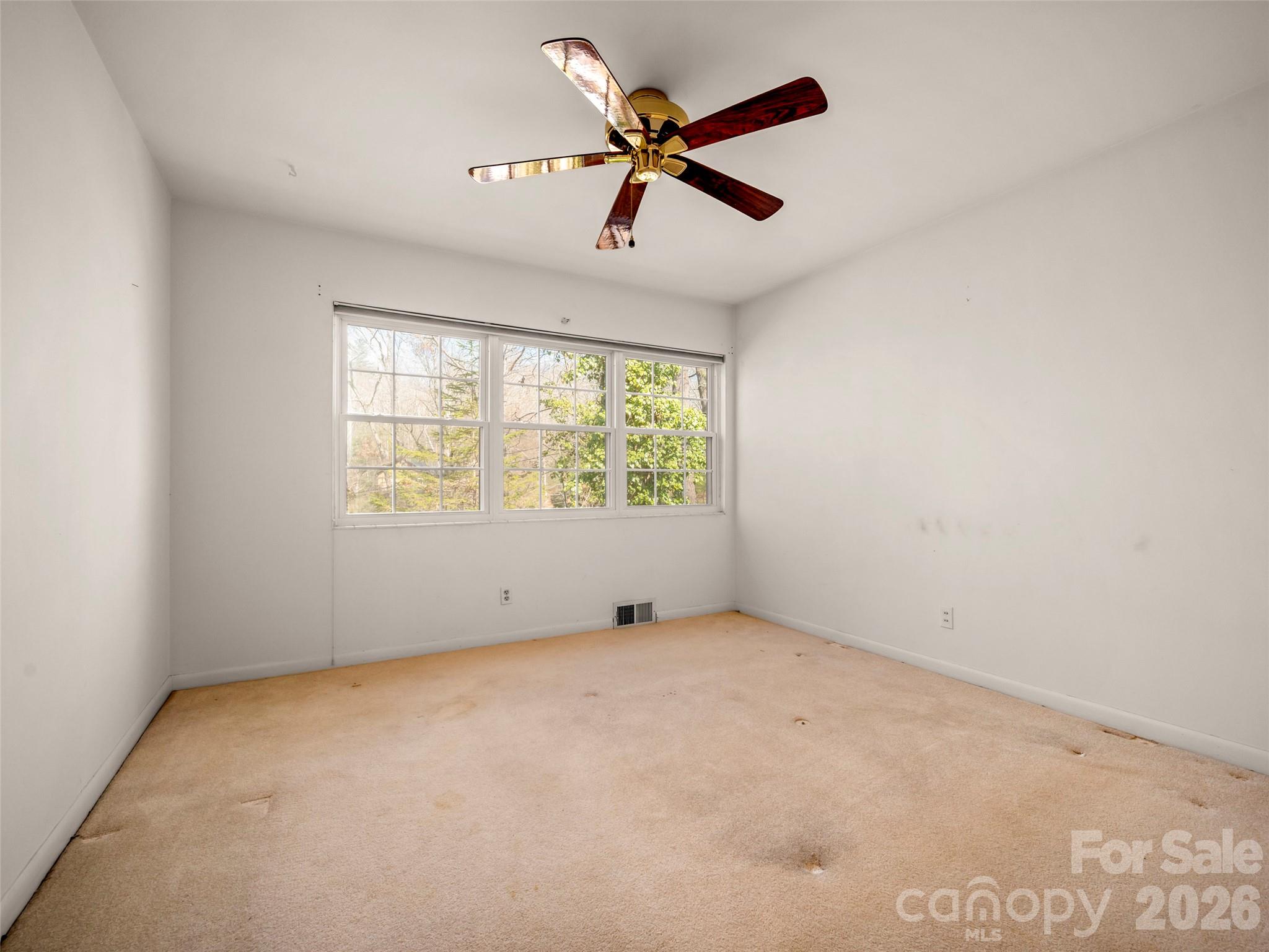 3 Country Road Hendersonville, NC 28791 - Photo 19 of 48 an empty room with ceiling fan and windows