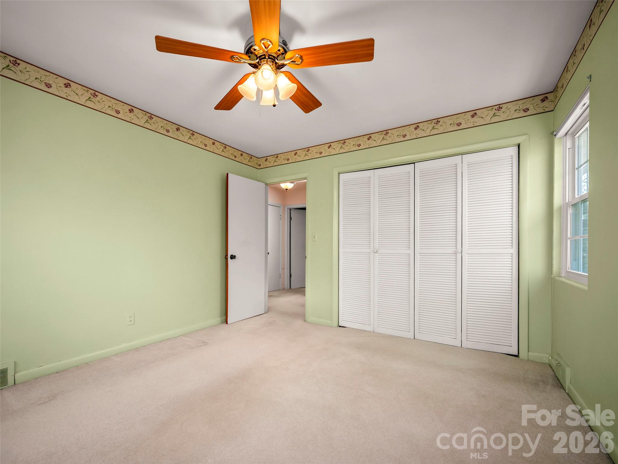 3 Country Road Hendersonville, NC 28791 - Photo 22 of 48 a view of a livingroom with a ceiling fan and window