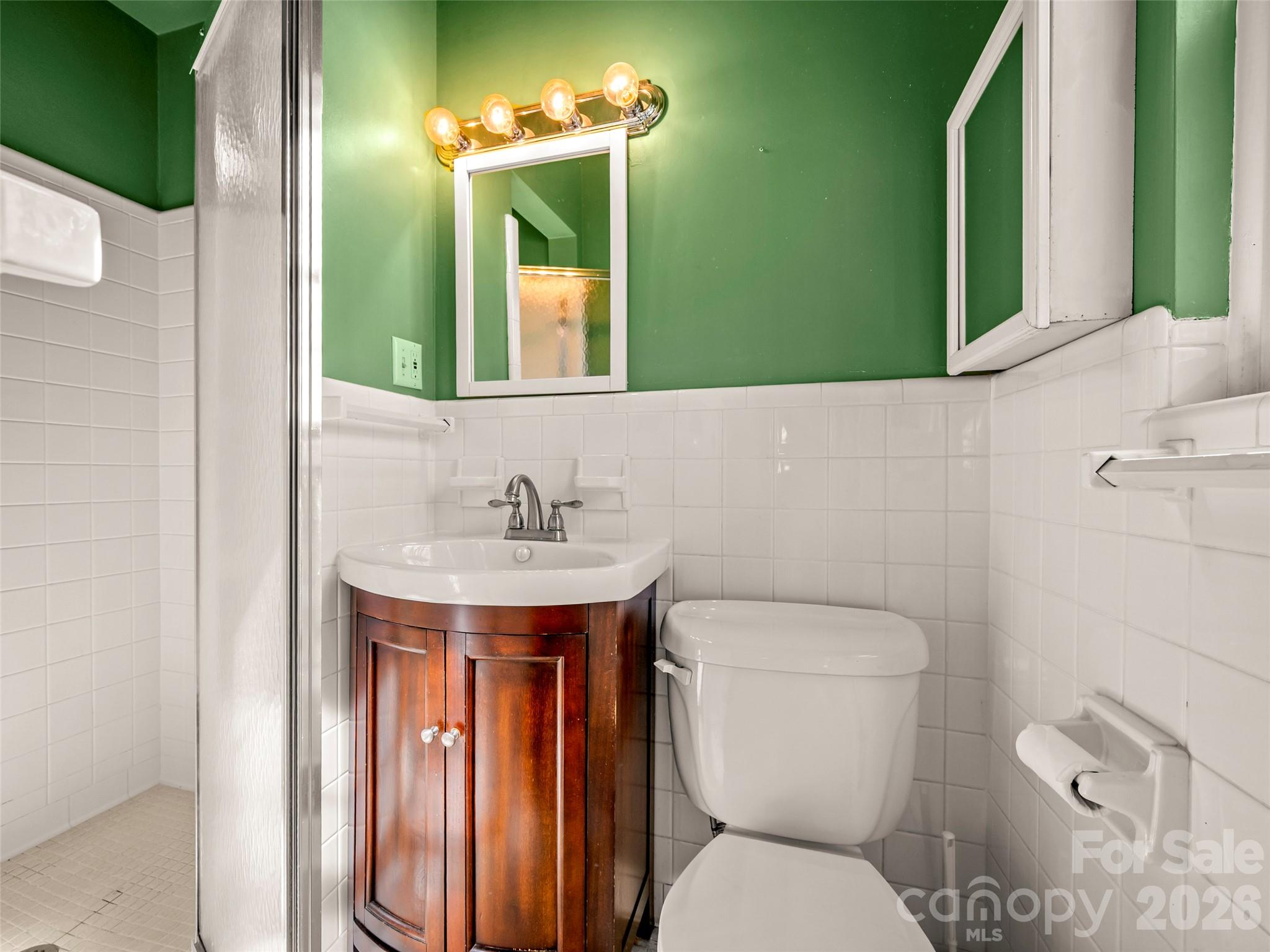 3 Country Road Hendersonville, NC 28791 - Photo 26 of 48 a bathroom with a toilet sink and mirror