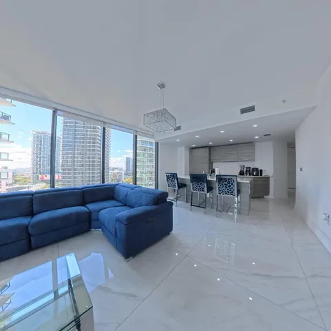 a living room with furniture and a floor to ceiling window