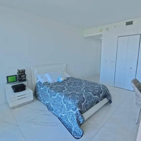 a living room with furniture a rug and a flat screen tv