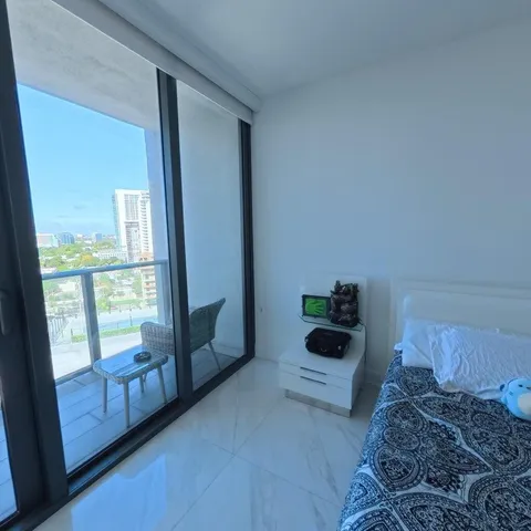 a bathroom with a granite countertop sink a toilet a large mirror a vanity and shower