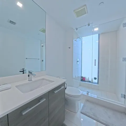 a bathroom with a sink a light fixture and a mirror