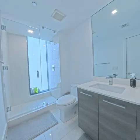 a spacious bedroom with a bed and a window