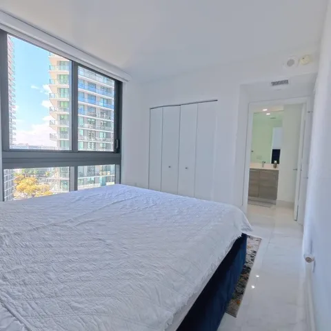a bathroom with a double vanity sink mirror and shower