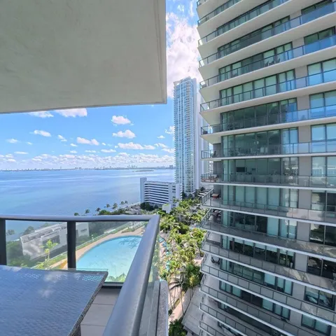 a spacious bedroom with a bed and a window