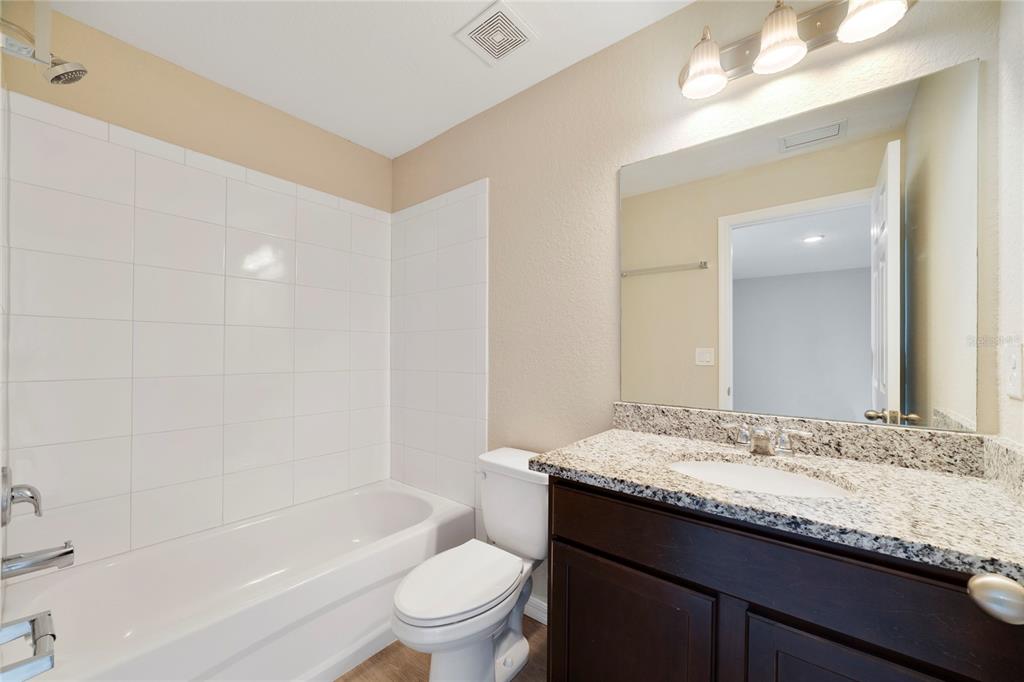 16271 Southwest 27th Terrace Road Ocala, FL 34473 - Photo 18 of 21 a bathroom with a granite countertop sink a toilet and shower