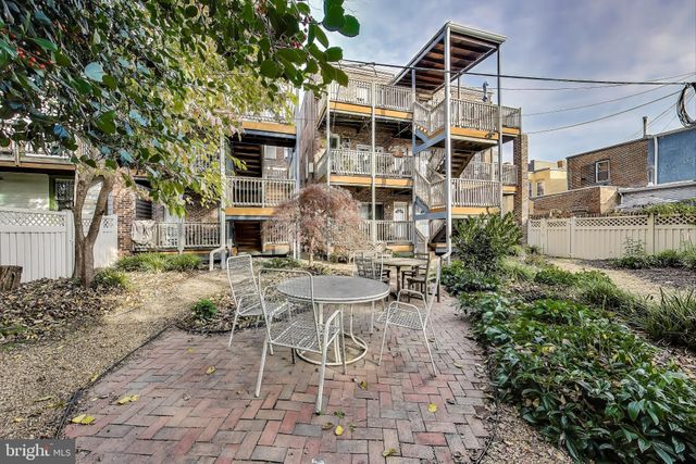 a view of a patio with table and chairs and potted plants