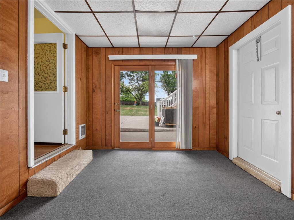 3046 Ridon Court Bethlehem, PA 18020 - Photo 27 of 41 A versatile room with paneled walls, direct outdoor access, and a durable carpeted floor.