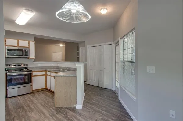 a kitchen with stainless steel appliances granite countertop a stove and a sink