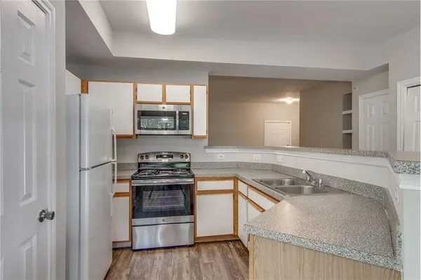 a kitchen with granite countertop a stove and a sink