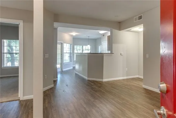 a view of a hallway with wooden floor