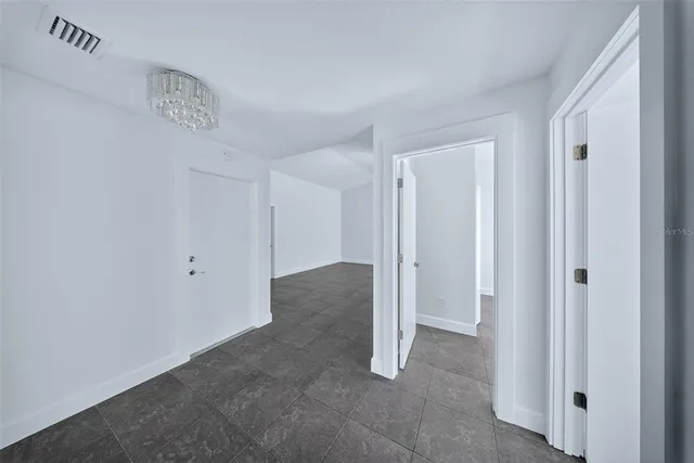 a bedroom with a bed a couch and a flat screen tv