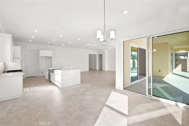 a view of a kitchen with a refrigerator and a floor to ceiling window