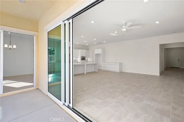 a view of a hallway with bathroom and glass door