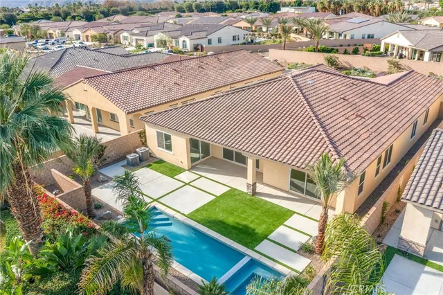 an aerial view of a house with a yard basket ball court and outdoor seating