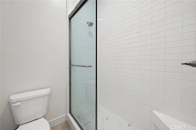 a bathroom with a toilet and shower