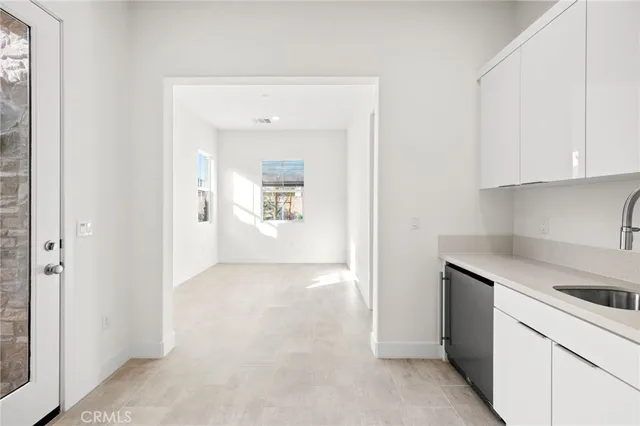 a view of a kitchen with white cabinets and a stove top oven