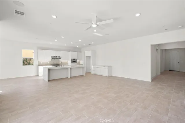 a view of a kitchen with a sink and a refrigerator