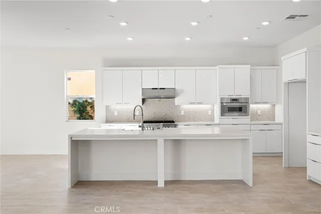 a kitchen with counter top space cabinets and stainless steel appliances