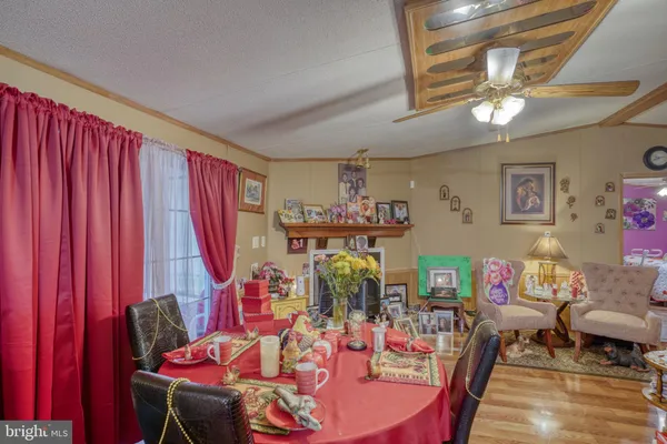 a view of a dining room with furniture and chandelier
