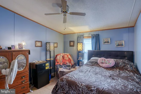 a bedroom with a bed and ceiling fan
