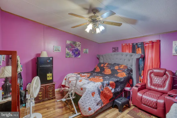 a bedroom with furniture and wooden floor