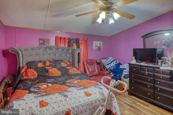 a bedroom with furniture and a flat screen tv
