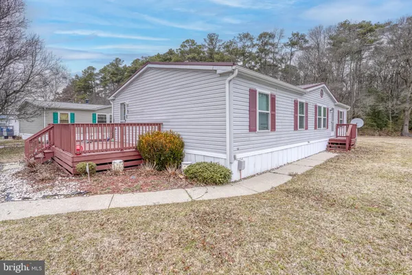a view of a house with a yard and wooden fence