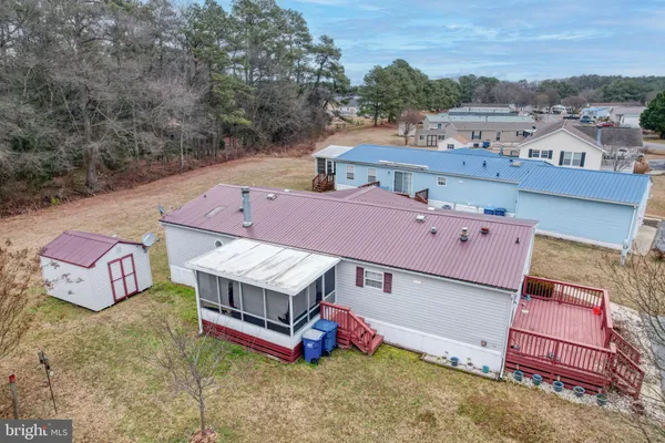 an aerial view of a house with a yard basket ball court and outdoor seating