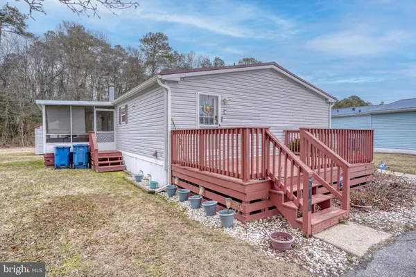 a view of a house with a yard and deck