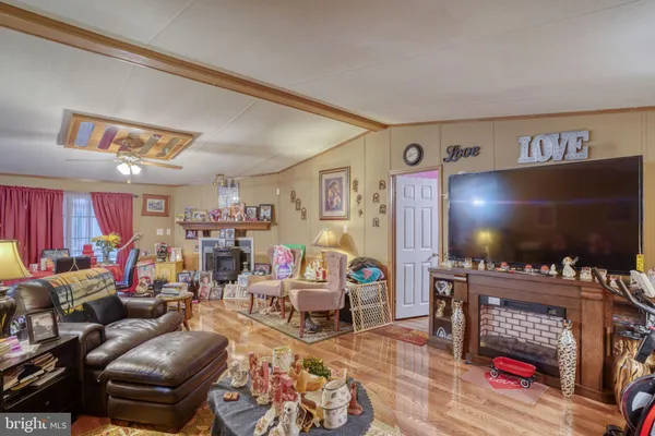 a living room with furniture a flat screen tv and a flat screen tv