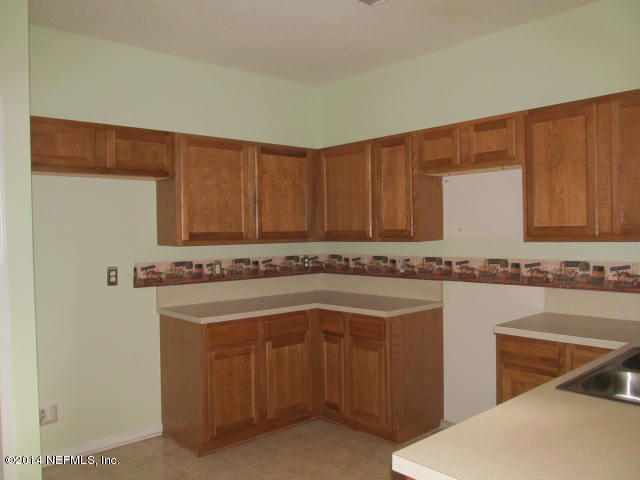 3641 Kirkpatrick Circle, Unit 1 Jacksonville, FL 32210 - Photo 3 of 11 a kitchen with a sink cabinets and wooden floor